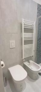 a white bathroom with a toilet and a sink at Esperia Maison B&b in Montesarchio