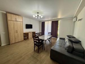 a living room with a couch and a table at BaBu shekvetili in Shekhvetili