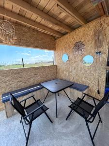 a picnic table and two chairs in a room at Summer Home Corbu in Corbu