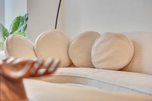 a person sitting on a couch with their hand on the cushion at Castillo 31 by Clabao in Pamplona