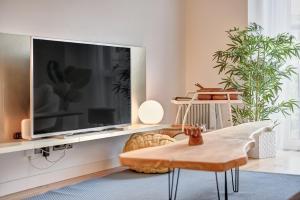 a living room with a large tv on a wall at Castillo 31 by Clabao in Pamplona +21 photos
