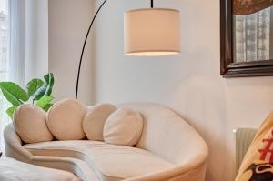 a chair in a living room with a lamp at Castillo 31 by Clabao in Pamplona