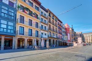an empty street in a city with buildings at Castillo 31 by Clabao in Pamplona