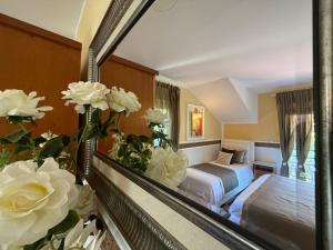 a reflection of a bedroom with a bed in a mirror at Grand Apartments Scepanovic in Tivat