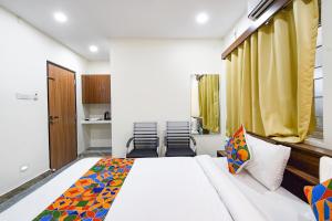 Ένα ή περισσότερα κρεβάτια σε δωμάτιο στο FabHotel Elite Inn
