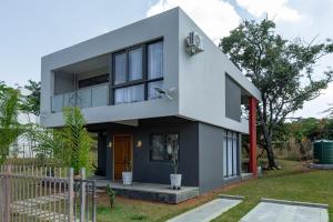 a modern house with a blue at The AntBox Kingsland City Ibexhill in Lusaka