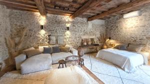 a bedroom with two beds and a couch at Moulin des Bergères in Mouriès