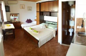 a hotel room with two beds and a bathroom at Apartments Bajo - FREE PARKING in Dubrovnik