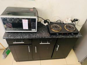a microwave and a radio sitting on a counter at Kasi Roots Living in Soweto +9 photos
