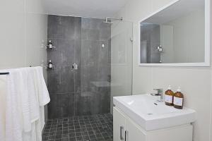a bathroom with a shower and a sink and a mirror at Mountain and Oceanview at Blouberg in Cape Town +34 photos