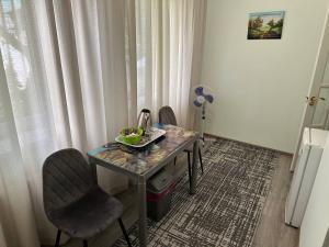 a table and two chairs in a room at Hotel Lidia in Chişinău