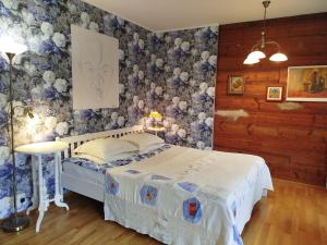 a bedroom with a bed with blue and white wallpaper at Matrix Garden Apartments in Tallinn