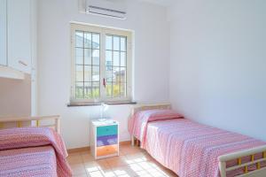 A bed or beds in a room at Villa delle Rose