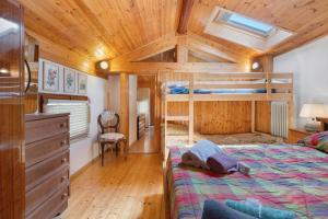 a bedroom with a bunk bed and a wooden ceiling at Casa della Rosina in Bresimo