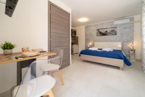 a bedroom with a bed and a table and chairs at Principe Umberto Luxury House in Solarino