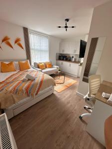 a bedroom with a bed and a living room at R4 - Luxury fully Self-Contained Studio with Private Bathroom and Kitchen in Halesowen +13 photos