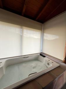 a bath tub sitting in the corner of a room at Divina Reserva- Cabana Alecrim in Bom Retiro +11 photos