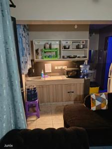 a living room with a kitchen with a counter at Secure 1 bedroom + lounge & 24hr cafeteria service in Nairobi