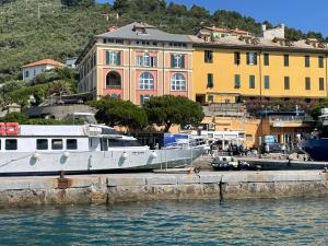 a white boat docked at a marina in front of a building at Appartamento fronte mare in Portovenere