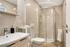 a bathroom with a shower and a toilet and a sink at Mirola homes - rent in nature in Zagorje ob Savi +34 photos