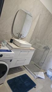 a bathroom with a sink and a mirror at Fotis Apartments Palaiokomi in Palaiokómi +11 photos