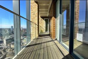 a balcony of a building with a view of a city at Luxury Nest in the City Glow in Woolwich
