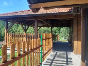 a wooden fence in front of a building with a gate at Villa Felix with spectacular pool in green oasis in Opatija