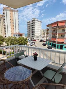 a table and chairs on a balcony with a view of a city at Apartamento Bellreguard Playa in Playa de Miramar