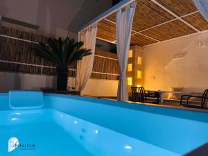 a blue bath tub in a room with a table at Annina guest house soggiorno vista mare in Savelletri di Fasano