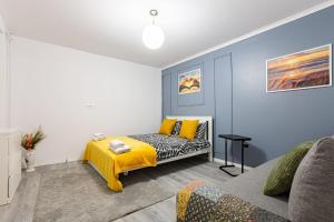 a bedroom with a bed with a yellow blanket at Studio Central, Relaxing&Cozy in Timişoara