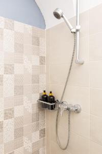 a shower with a shower head in a bathroom at Studio Central, Relaxing&Cozy in Timişoara +33 photos