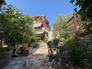 a courtyard with potted plants in front of a building at Grand Apartments Scepanovic in Tivat