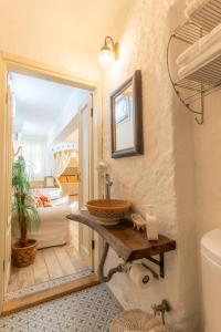 a bathroom with a sink and a toilet in a room at Mon Ilıca Otel in Çeşme +88 photos