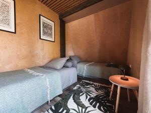 a room with two beds and a table in it at Mulberynas in Stakliškės