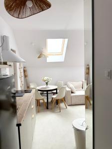 a kitchen and living room with a table and chairs at Apartament Szyszka 2 in Rogowo +12 photos