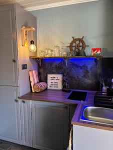 a kitchen with a sink and a counter top at Pirate's Cove in Sukošan
