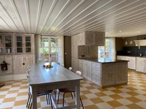 a large kitchen with a table and a counter top at Villa-Agave , by the sea in Porto-Rafti outside Athens in Porto Rafti