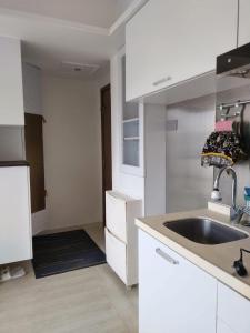 a kitchen with white cabinets and a sink at Prince Edward, 1 mins dining & transportation in Hong Kong