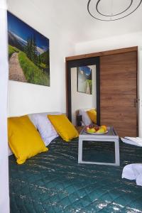 a bedroom with a bed with a tray of fruit on it at Żywiec Apartament - Parking&Balcony - by Rentujemy in Żywiec +7 photos