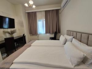 Postel nebo postele na pokoji v ubytování Hotel MB