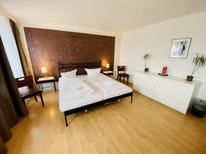 a bedroom with a bed and two tables and chairs at Doppelzimmer Lounge, direkt am Alten Strom in Warnemünde