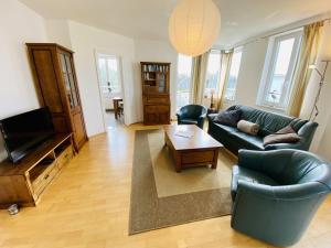 a living room with a couch and a television at Marthes Seeblick in Warnemünde