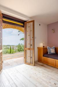 a bedroom with a bed and a sliding glass door at Villa Afrodite in Mondragone