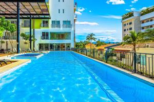 a swimming pool at a hotel with a building at Viva la vida in Bucerías