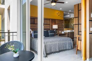 a bedroom with a bed and a balcony with a kitchen at Viva la vida in Bucerías +32 photos