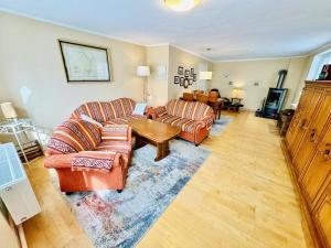 a living room with two couches and a table at Ferienhaus Maria in Warnemünde