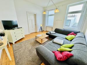 a living room with a couch and a tv at Seerose in Warnemünde