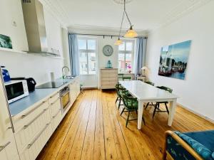 a kitchen with a table and a dining room at Seerose in Warnemünde