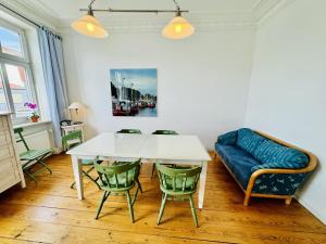 a living room with a table and a couch at Seerose in Warnemünde +15 photos