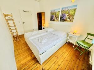 a bedroom with a bed and a desk and a ladder at Seerose in Warnemünde